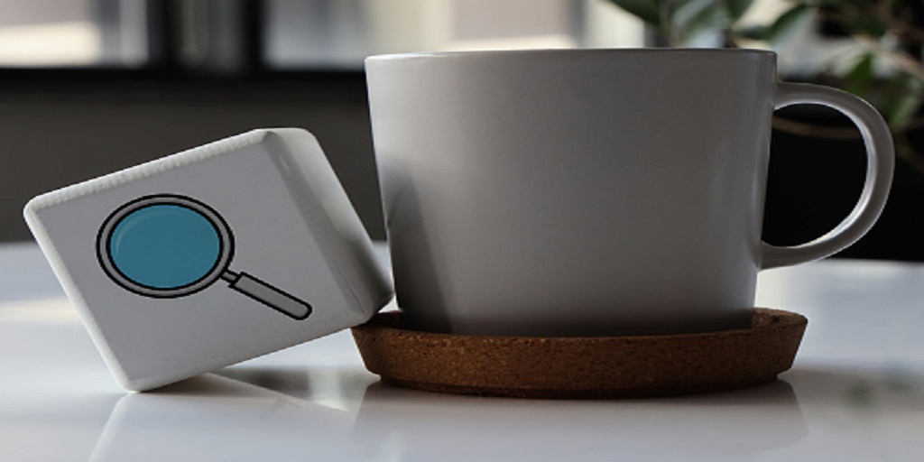 Coffee cup and magnifying glass